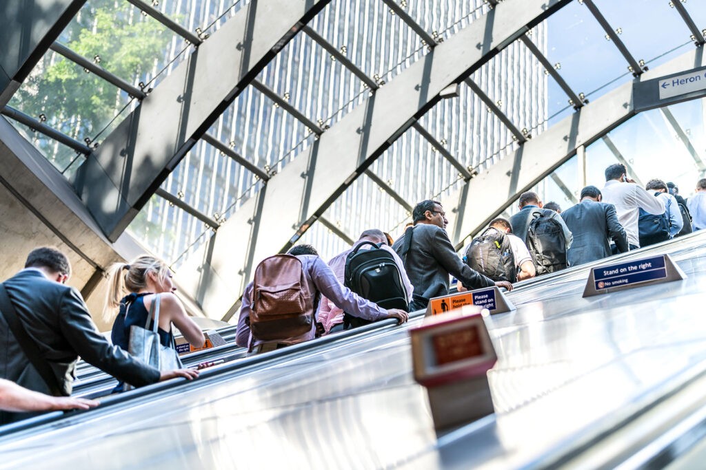 Commuters riding an escalator on the London Underground.
