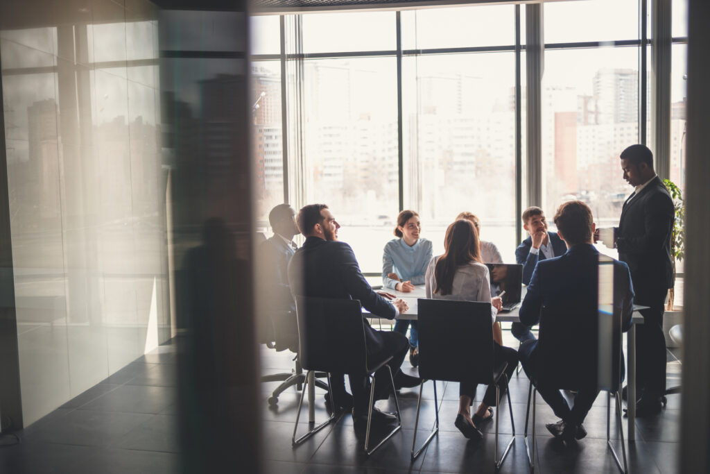 A group of employees in an office meeting.