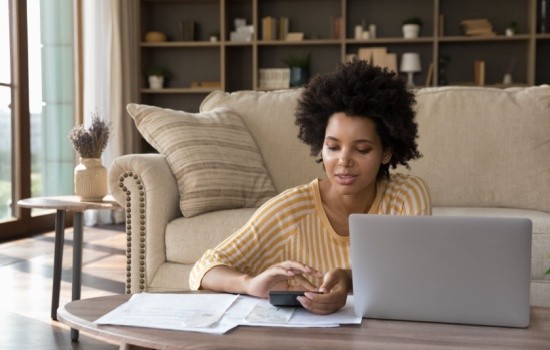 A woman reviewing some paperwork at home.